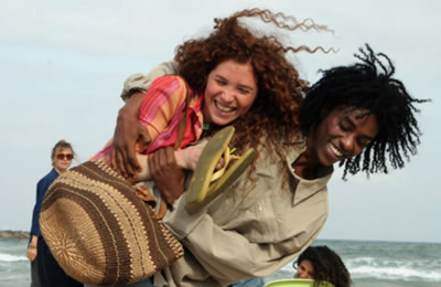 Image from LIVE AND BECOME - Lovers, Shlomo (Sirak Sabahat) and Sarah (Roni Hadar) walking arm-in-arm on the beach
